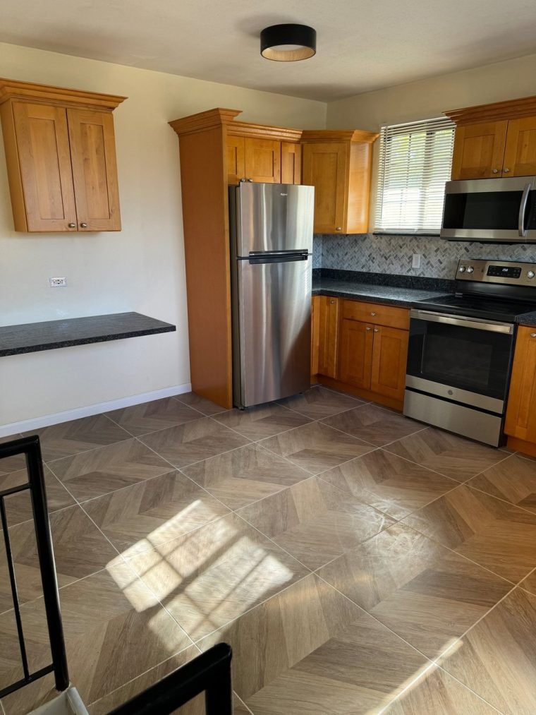 Blue Pearl granite with a marble herringbone backsplash.