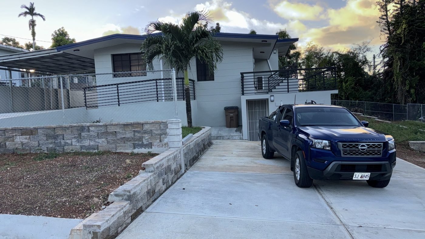 The same house after renovation, with a relocated stair entrance and extended balcony